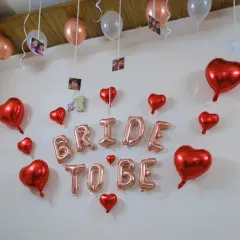 This image shows the details of the hanging photos and balloons, creating a personalized touch for the bridal shower.