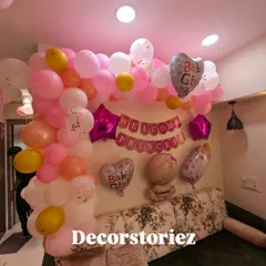 A closer look at the pink balloon wall decoration for a 'Welcome Princess' celebration. It includes 'Baby Girl' foil balloons and a mix of soft pinks, whites, and gold.