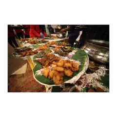 Bringing the world to your table. This image shows a buffet line with starters served on banana leaves, showcasing a traditional yet elegant setup for a large gathering.