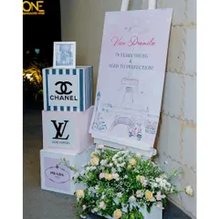 The welcome area for a "Parisian Luxury" 70th birthday. We used custom signage and props inspired by high-fashion brands to immediately introduce the chic and celebratory theme.