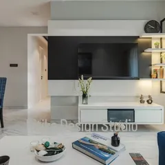 A closer look at the entertainment wall, highlighting the clean lines of the floating console and the ambient light from the display shelves. This setup is designed to be the focal point of the room without overwhelming the space.