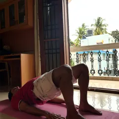 A demonstration of Setu Bandhasana (Bridge Pose) during a personal session at home, a pose excellent for strengthening the back and glutes.