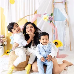 Pure joy during a Mother's Day mini session. A mother laughs with her two sons, creating a memory filled with love and happiness.