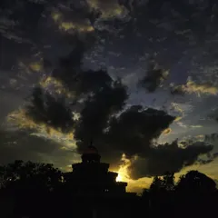 The silhouette of the Vishalakshi Mantap against a dramatic sunset sky. Just as nature's colors change, our moods also shift, but our true self remains the constant, silent witness.
