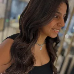 The client is all smiles with her new hot chocolate hair. The warm brown tones are incredibly flattering and give her hair a healthy, glossy finish.