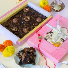 Here is my Chocolate Tile from the Raksha Bandhan 2023 collection. It's a slab of rich, dark chocolate loaded with Ferrero Rocher, brownie chunks, and crunchy nuts, presented in a festive pink box with a cute Rakhi tag.