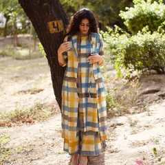 This image showcases the full three-piece co-ord set in a candid, natural pose. The soft lighting emphasizes the texture of the handloom fabric, while the full-body framing provides a clear view of the outfit's silhouette and proportions.
