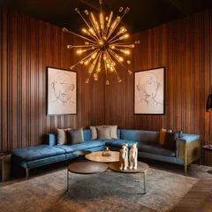 I designed this living room to feel both grand and intimate. The vertical wood wall panelling provides a warm, textured backdrop that envelops the space, creating a sophisticated sanctuary for relaxation and conversation.