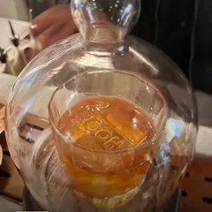 For our signature Butter Old Fashioned, presentation is key. The cocktail is served under a glass cloche filled with smoke, which infuses the whiskey with a beautiful aroma before the first sip.