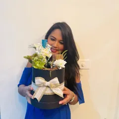 A happy client with her custom hamper in a black round box. I love seeing the joy my creations bring.
