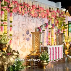 This angle showcases the depth and richness of the decor. I layered traditional elements like brass cow statues and floral arrangements to build a scene that feels both opulent and deeply rooted in our culture for this beautiful namkaran.