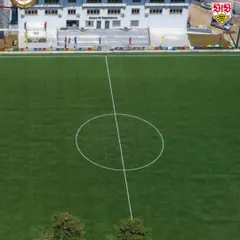 An aerial view of the pristine football pitch at the Bhutan Football Federation. We partner with organizations that share our commitment to quality infrastructure.