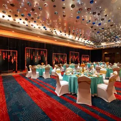 This Sajjangoth dinner was a feast for the eyes. We used a vibrant turquoise and marigold color palette, with hundreds of hanging glass baubles on the ceiling to create a shimmering, magical canopy over the guests.