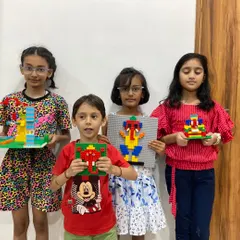 A group of students proudly display their unique LEGO Ganesha creations from our Ganesh Chaturthi workshop. These events combine cultural learning with creative engineering.