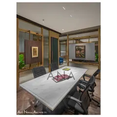 The conference room at Jain Cosphere Office is designed for 4-6 people, with a glass partition that uses both clear and fluted glass for privacy. A central panel is cleverly utilized to display artwork.