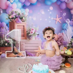 Look at that pure, unfiltered joy! A first birthday is a huge milestone, and my mermaid-themed cake smash sessions are perfect for making a huge, happy splash to celebrate.