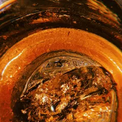 A close up of the 'King Kunta' cocktail, showing the gold flakes suspended in the drink. I focus on these small, luxurious details to create visually rich content that showcases the quality and creativity of a menu.