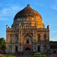 A direct, symmetrical shot of the main tomb at Lodi Garden, bathed in the warm light of the setting sun. A classic view of this iconic Delhi landmark.