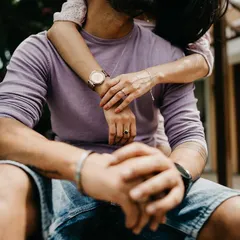 A close-up detail shot focusing on the couple's embrace and intertwined hands. Sometimes the smallest details tell the biggest story of love and connection.