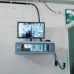 A complete setup for a small office in Varthur, showing the monitor and the locked network rack mounted securely on the wall.