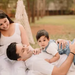 A sweet moment with baby relaxing on dad's chest. Outdoor sessions allow for plenty of cuddles and connection.