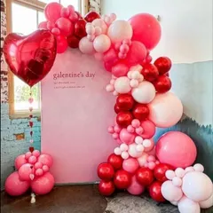 A closer look at the Valentine's Day balloon arch, highlighting the mix of different sized balloons that create a rich texture. This setup is perfect for creating memorable photos.
