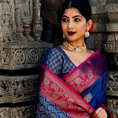 Modeling a magnificent royal blue and pink Kanjivaram silk saree against the backdrop of ancient temple carvings. This shoot was about capturing a feeling of queenly elegance and reverence, letting the rich fabric and traditional jewelry shine.