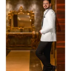 The groom, looking sharp and confident. I make sure our heroes get their own stylish portraits, capturing their personality before the big moments.