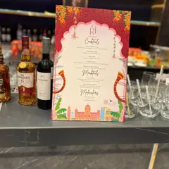 We design custom menus that match your event's theme and aesthetic. This beautifully designed menu for a wedding celebration clearly lists the curated cocktails, mocktails, and malts available for guests.