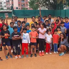 This is my team, my family. This picture captures the amazing energy of a group session at the academy. We welcome players of all ages, creating a supportive and enthusiastic environment for both kids and adults to learn and grow in tennis.