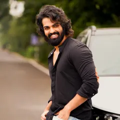 A casual lifestyle shot by a car, showing a friendly and approachable personality. This is great for commercial and everyday character roles.