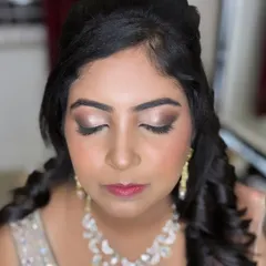A classic reception look for this beauty. The focus is on a soft brown smokey eye that defines and elongates the eyes, paired with a subtle pink lip and glowing skin. It's glamorous yet feels light and comfortable.