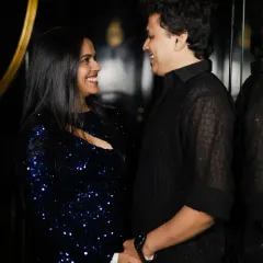 A happy, candid shot of the couple sharing a laugh. Their genuine smiles show the joy of their celebration.