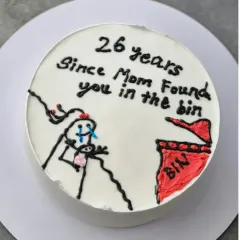 The full view of the "26 years since Mom found you in the bin" cake. This Vanilla Nutella Chocolate cake is a great example of a fun, personalized request.