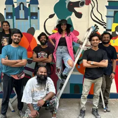 The full team of artists and collaborators for the Wall Art Festival, standing proud in front of our finished mural. It takes a village to tell a story this big.