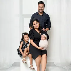 A complete family portrait featuring parents, a proud older sister, and the newest little member. I style these shots to be classic and elegant, perfect for framing.