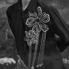 A monochrome detail shot of our Azalea Co-ord Set, showcasing the delicate, hand-beaded floral motifs with hanging tassels.