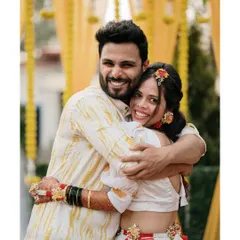 A big, joyful hug during the Haldi ceremony. This image is bursting with energy and happiness, perfectly capturing the fun spirit of the event.