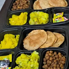 Celebrating a festival at home? Our packed thalis are the perfect solution. This Ganesh Chaturthi special meal includes puri, sukha kala chana, aloo sabzi, and halwa, all prepared without onion or garlic.