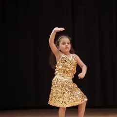 Every star has a beginning. This is one of our 'Little Champs' performers, capturing the joy and focus we nurture in our youngest dancers from their very first show.