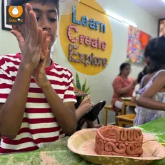 This student is using the coiling technique, a method inspired by ancient Indus Valley pottery. Building pots this way is a meditative process that teaches construction and patience.