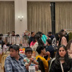 Even with seating areas, the aisles remain busy. This image captures the density of the crowd and the engaged atmosphere of the event.