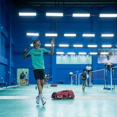 A junior player in mid-air, executing a perfect smash during the PSB Open. We provide a stage for young talent to express their skills and athleticism in a competitive setting.