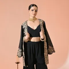 A full view of the festive look, showing how the gold-toned temple choker stands out against the black outfit, creating a modern yet traditional vibe.