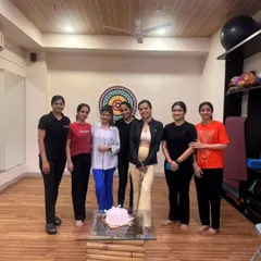 A group photo with one of our beloved members and her celebration cake. This is what our community is all about.