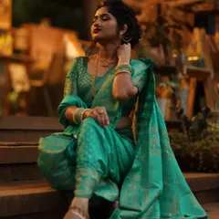 The grace of a Nauvari saree. This traditional Marathi look is all about poise and elegance, with a classic updo, subtle makeup, and the unique drape of the nine-yard saree.