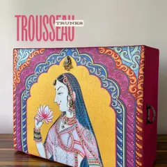 This vibrant trousseau trunk, featuring a traditional Pichwai-style painting of a queen, is a piece of art in itself. It’s designed to be a stunning centerpiece for your trousseau display.