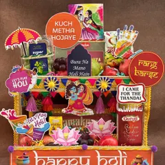 Bringing a *rangeen* blast to your Holi celebrations! This hamper is designed to look like a vibrant street stall, packed with fresh fruits, thandai, gujia, and fun props like water guns and colors to get the party started.