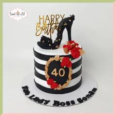 A "Lady Boss" cake for a fabulous 40th birthday. This design is bold and stylish, with black and white stripes, a handcrafted black stiletto topper, and accents of red roses and gold.