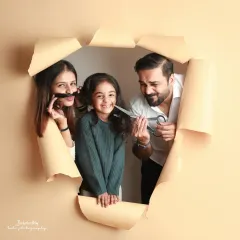 Breaking through the ordinary! This creative paper-tear concept was a fun way to capture a playful family portrait, with everyone peeking through.
